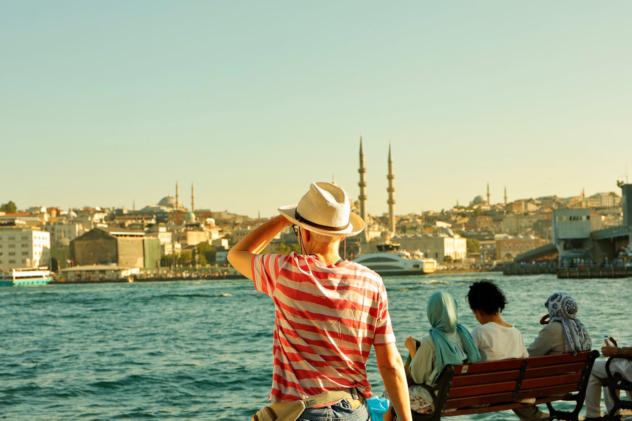 gallery-6 A tourist enjoys the Istanbul skyline across the Bosphorus, capturing historic architecture.